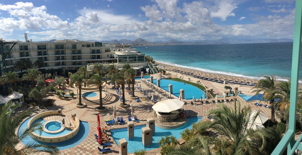 Aerial view of Casino Loutraki club hotel large garden with simmins pools and the nearby sea view.