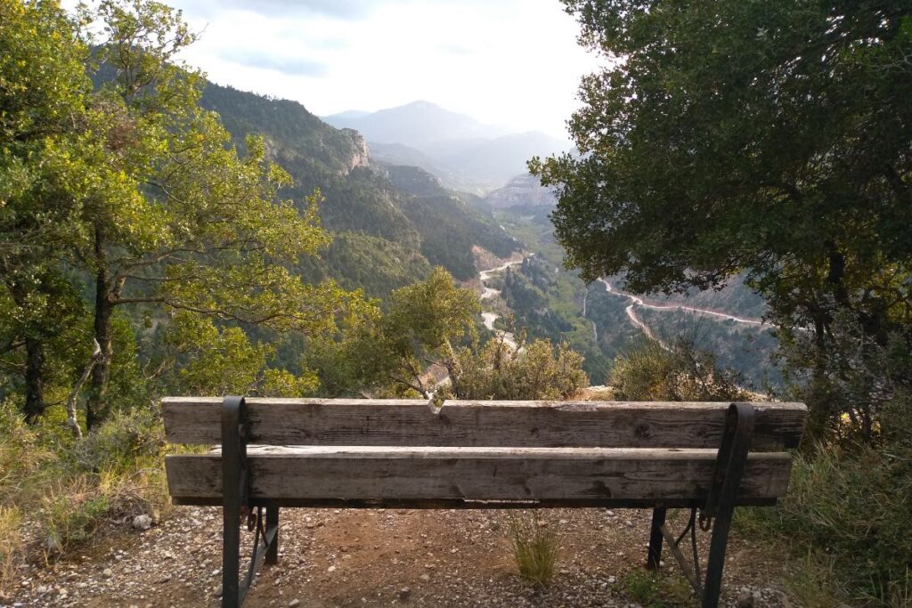 A wooden bench across a mountain in Greece