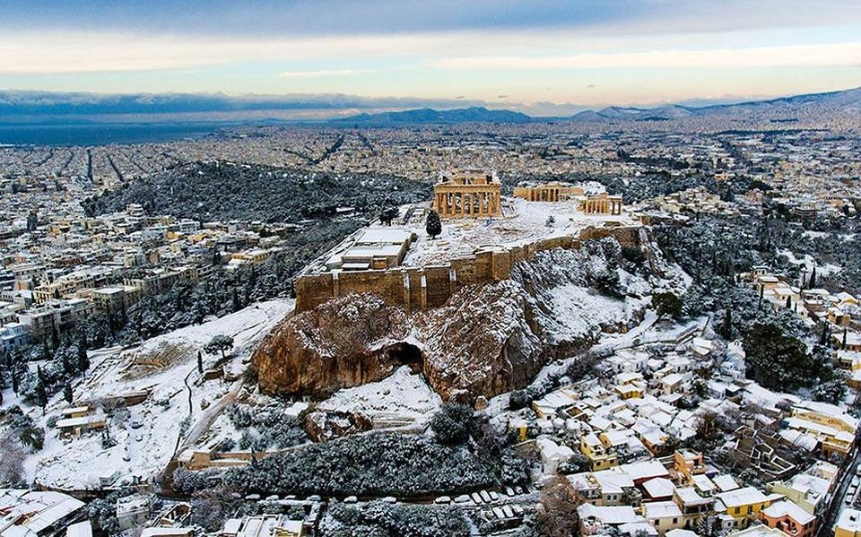 Parliament lit for Christmas Athens Acropolis in snow during winter. Christmas in Athens Greece.