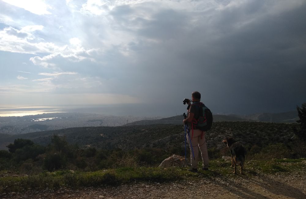 Best Hikes near Athens, hiker with a dog on Aigaleo mt in Athens Greece