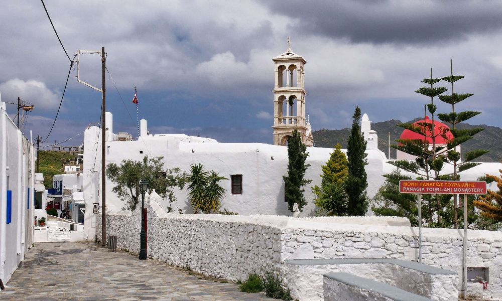 A whitewashed Tourliani monastery with clouds 
In Mykonos Island.