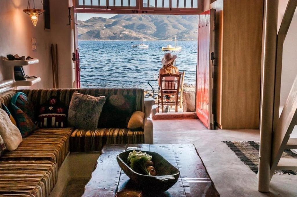 Dream Boathouse Room with View in the Sea and a Person Sitting  in Milos Island.