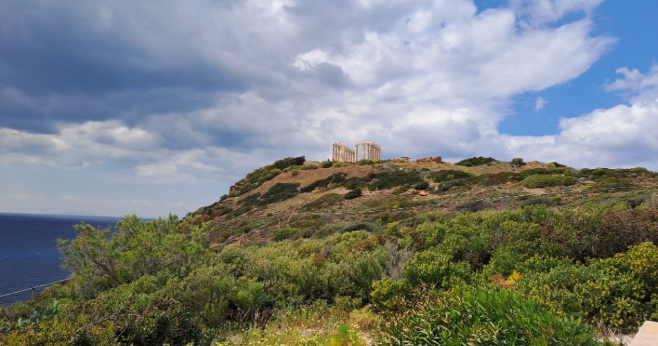 Temple of Poseidon with Blue Sky and a lot of Green in Sounion Cape Athens Greece.