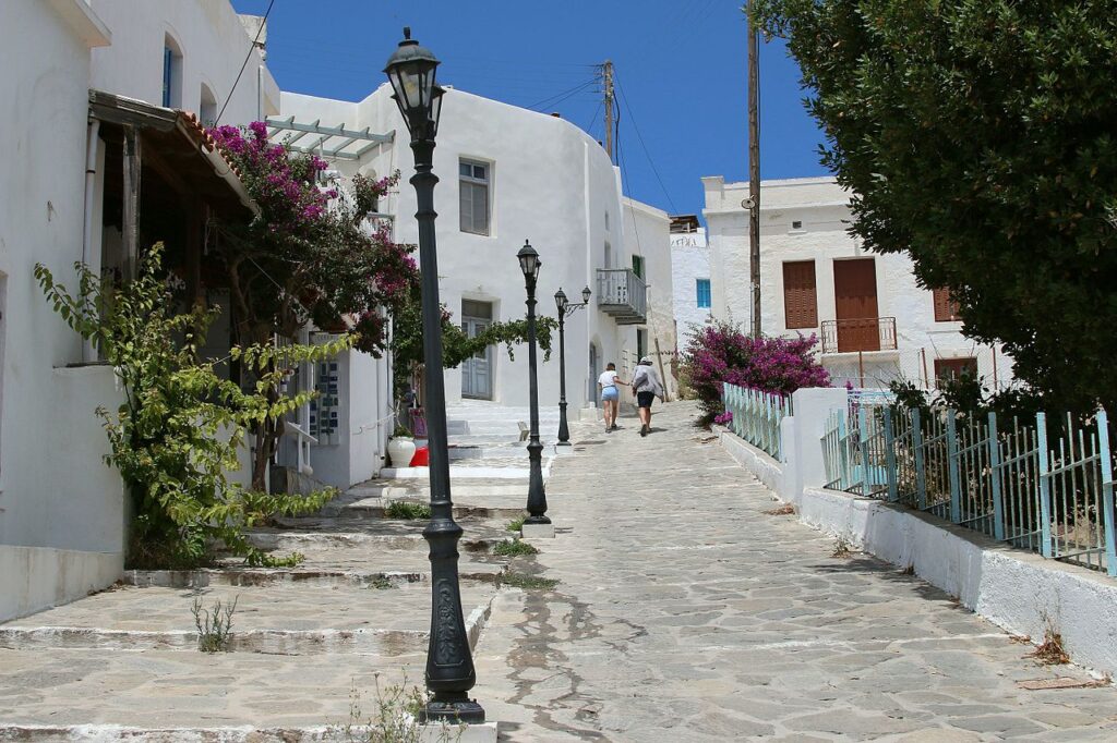 Traditional alley in Plaka With Two People Walking  in Milos Island.