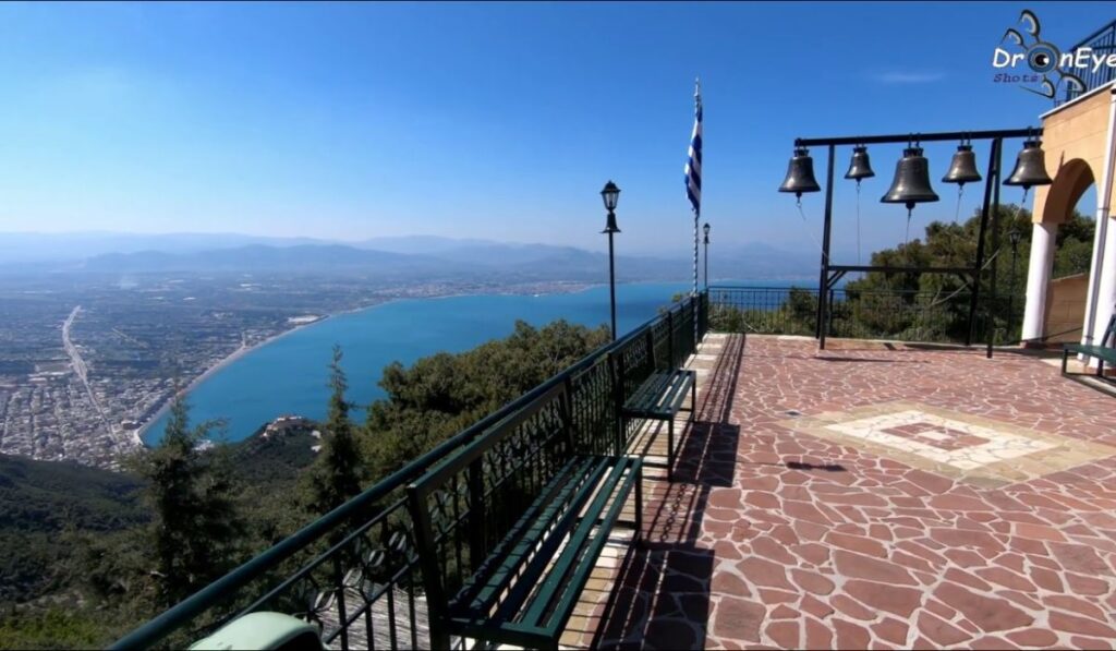 Things to Do in Loutraki Greece:  Potapios Monastery impressive balcony with bells view of Loutraki town and the sea 