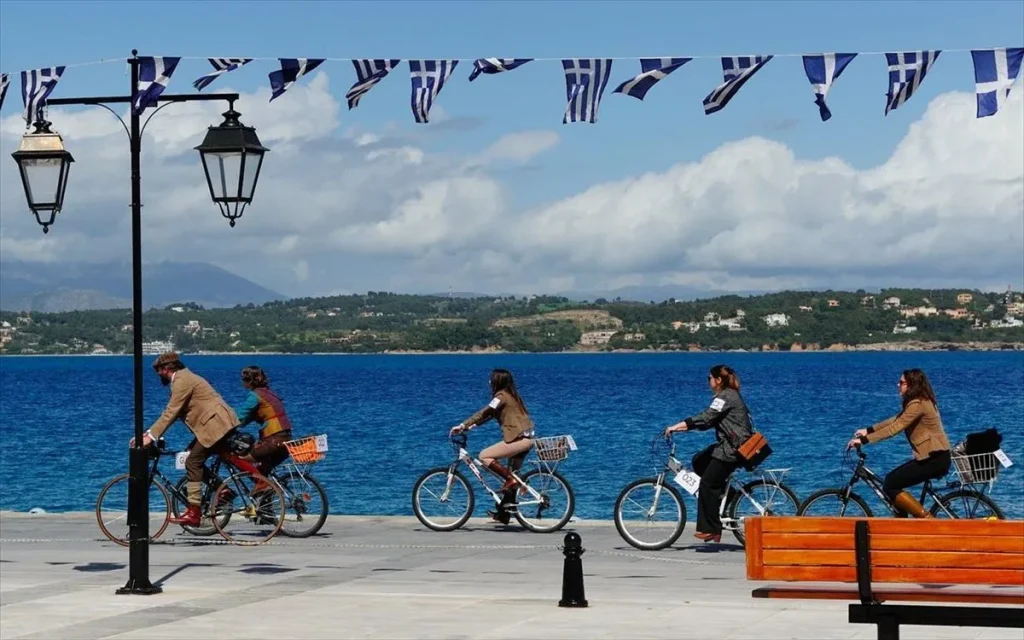 Some bikers near the sea in a sunny day and some small Greek Flags in Spetses Greece.