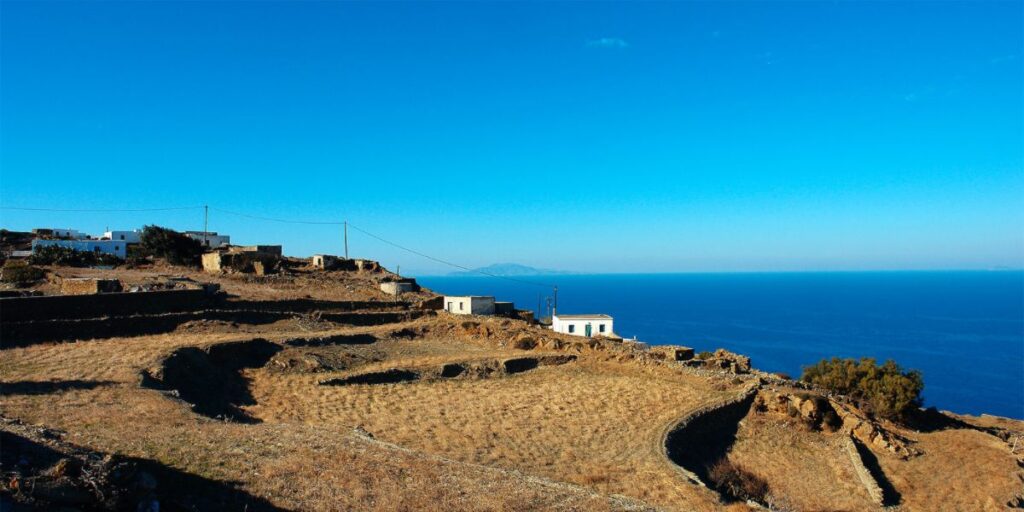 Some whitewashed houses on the cliff with view to the sea in Ano Meria in Folegandros Greece. 