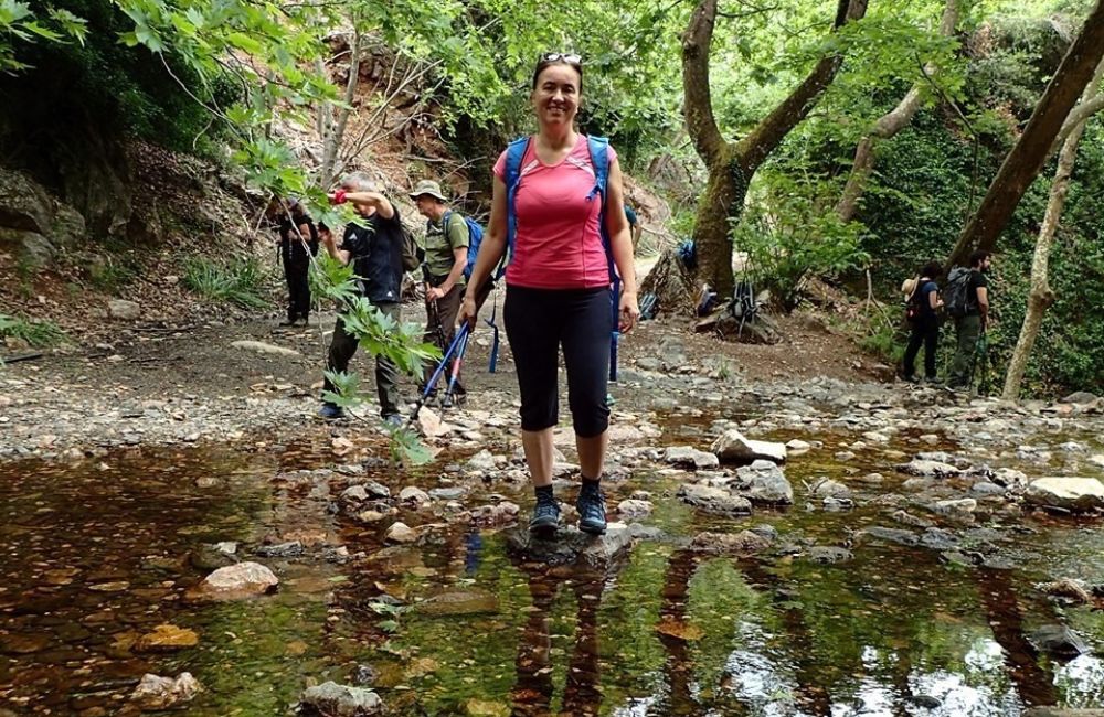 Evgenia hiking in a stream and some other hikers.