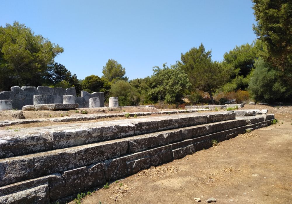 The Temple of Nemesis in Ramnous with some trees in a sunny day in Athens Greece.