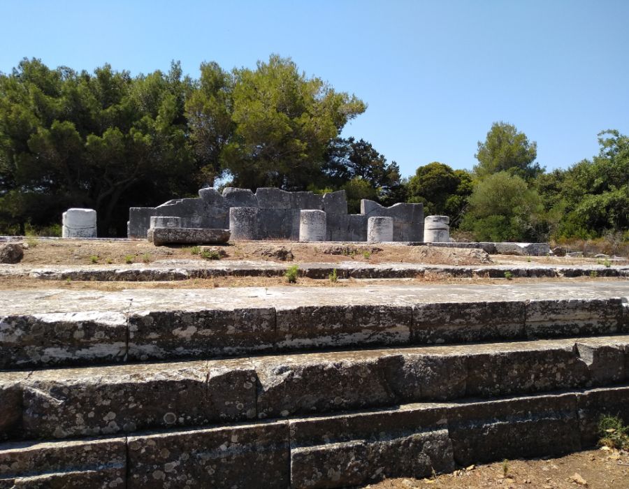 Nemesis Temple with trees in a sunny day in Ramnous Archaeological Site in Athens.