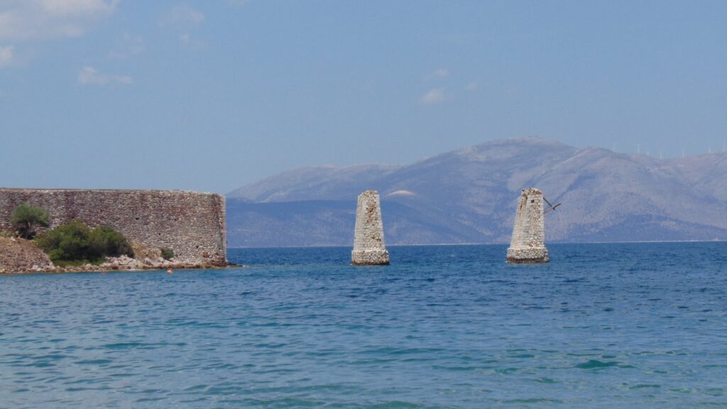 Remains of the bridge in the sea in a sunny day in Ramnous Archaeological Site in Athens.