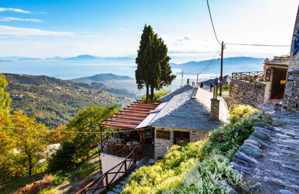 A beautiful view to Volos and a house surrounded with trees in Pelion Greece. 