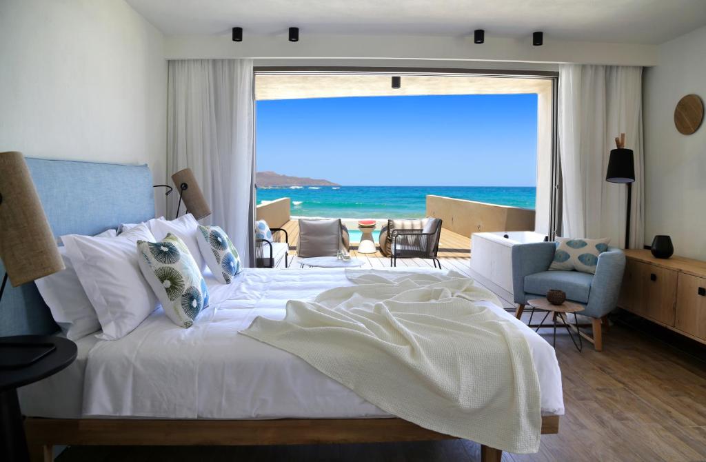 A hotel room with double bed with a view to sea and swimming pool in Chania Crete Greece.