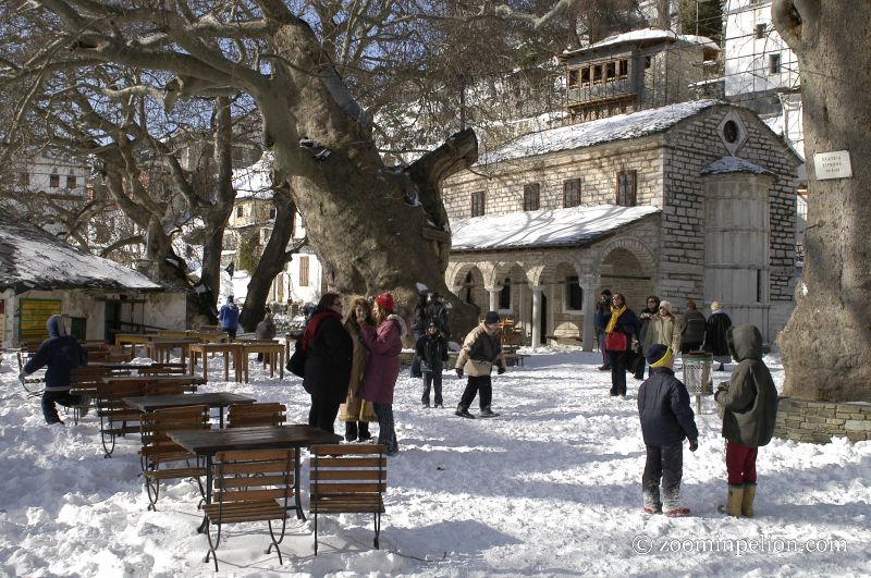 Makrinitsa's Main Square with snow and many people in Pelion Greece.