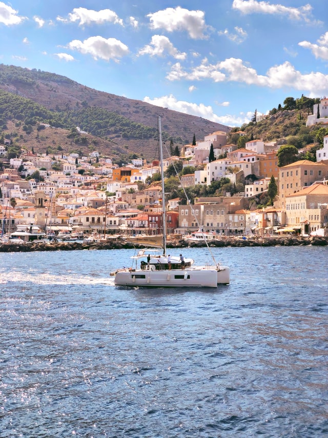 A yacht is sailing in front of Hydra port