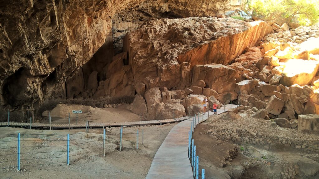 Frangthi cave and two people walking in Ermionida Peloponnese Greece.