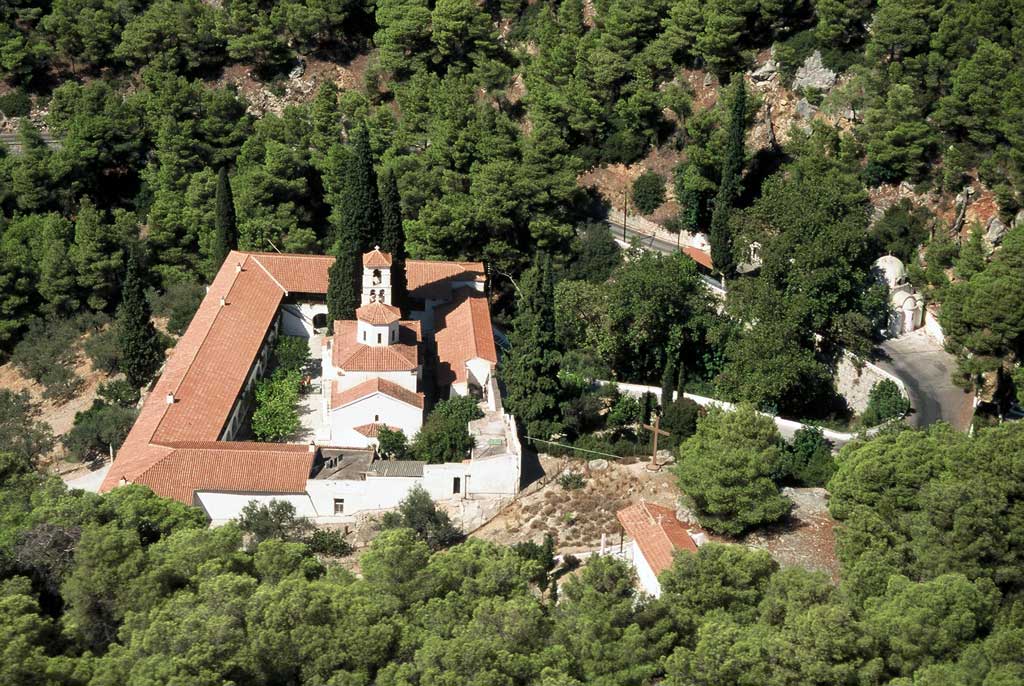 A monastery surrounded of trees taken from a drone in Poros Island Greece. 