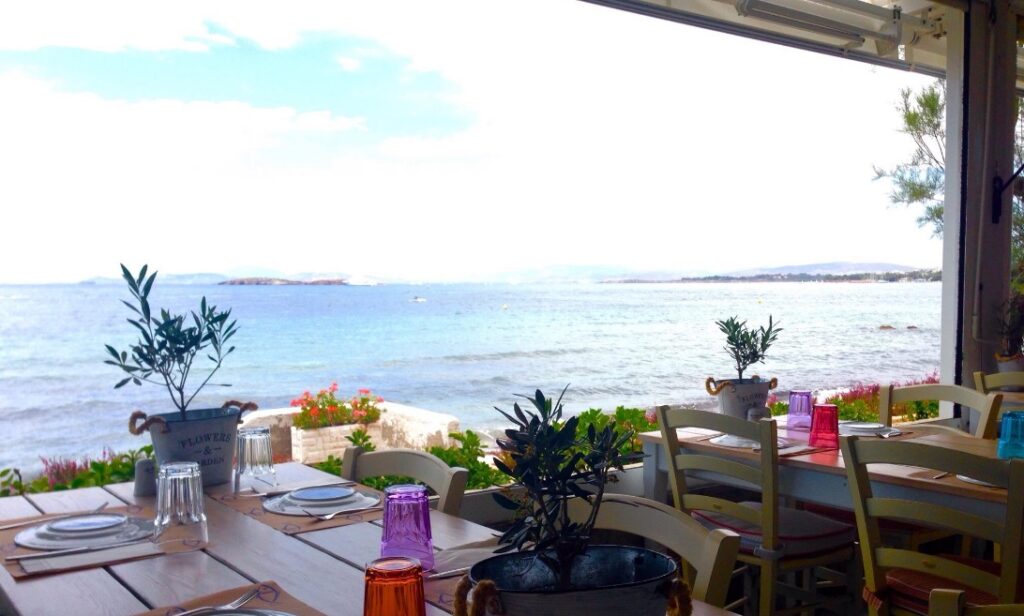 Garbi seafront fish restaurant set tables by the water in Athens Greece.