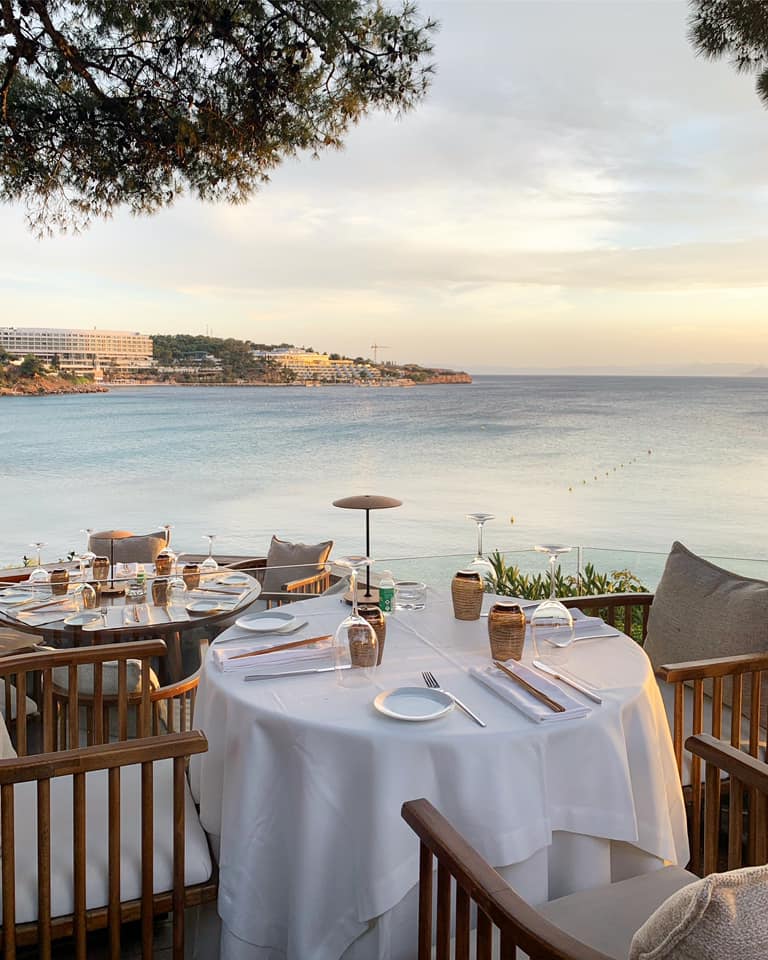 Ithaki seaside  restaurant with the Four Seasons Hotel in the background in Athens Greece.