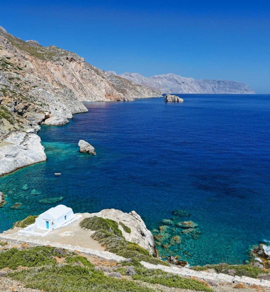 Stunning coastline near Agia Anna with deep blue water and rocky cliffs in Amorgos Greece, ideal for showcasing things to do in Amorgos.