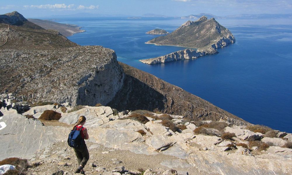 A young woman is Hiking Island Amorgos