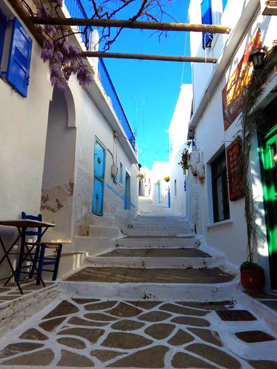 An alley with whitewashed steps and houses on the sides in Amorgos Island Greece.