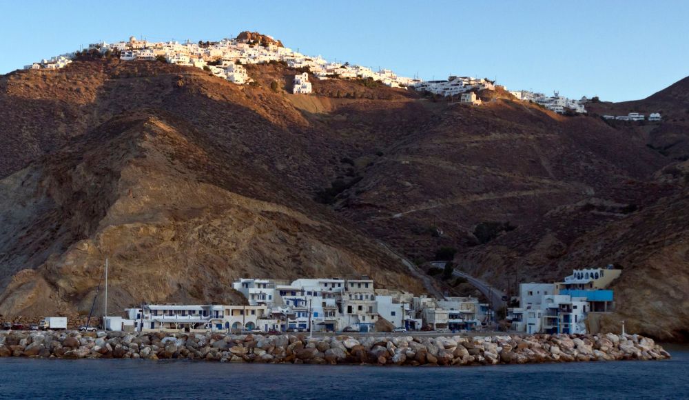 The Anafi port and the Anafi Chora on top of the mountain in Anafi Island Greece.