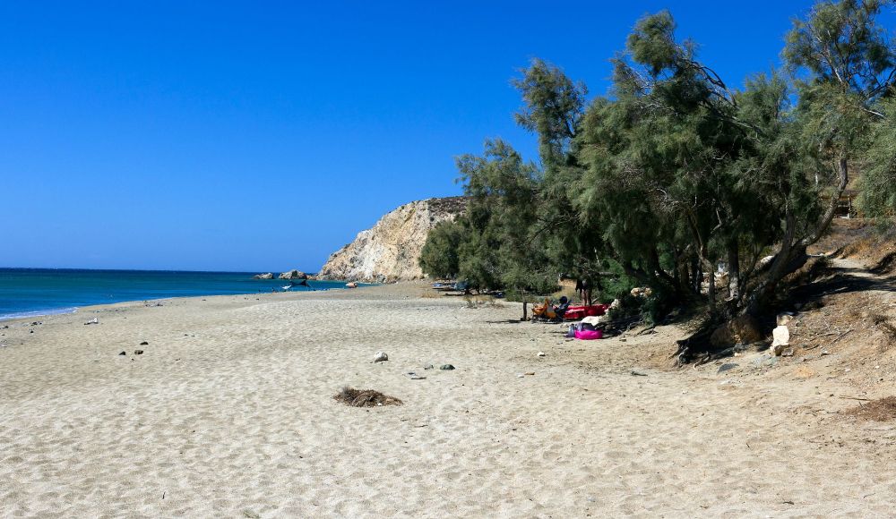 The sandy beach of Roukounas and some people in Anafi Island 