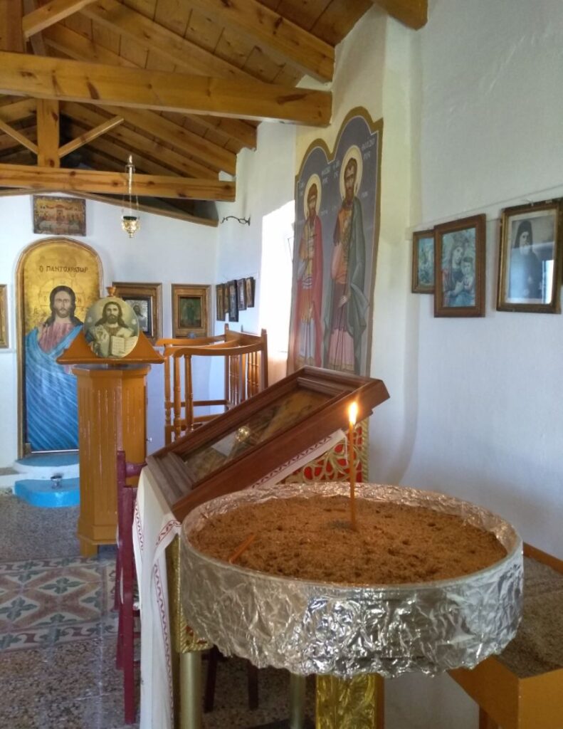 Chapel's interior with a lit candle in Agistri island
