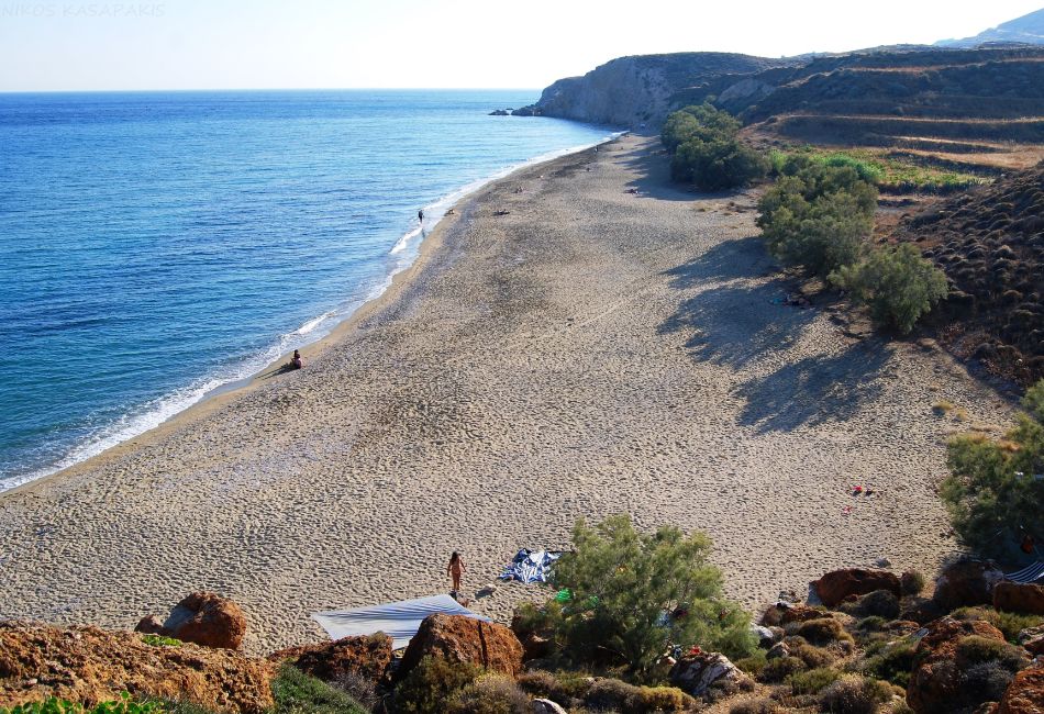 Roukounas sandy Beach in Anafi island in Greece with only 3 people at the beach. 