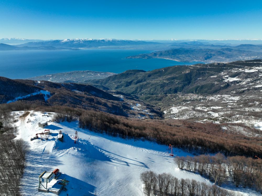 Ski resort in Pelion Greece by a drone. You can see the sea and the snowclad slope. 