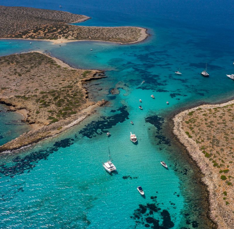 Yachts in emerald islets in Paros island Greece