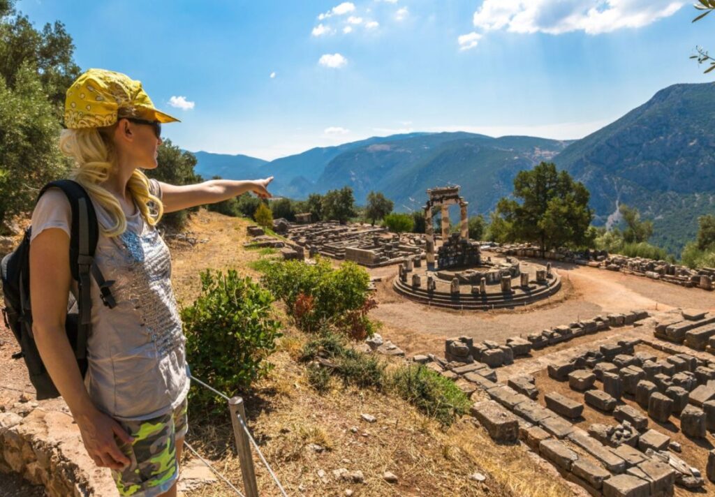 First Time to Greece, Woman pointing at Delphi site