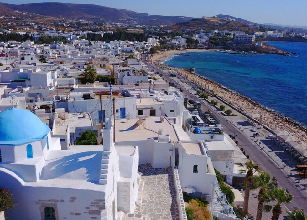 Parikia town and port of Poros island in the CYclades Greece with whitewashed houses and a long coast.