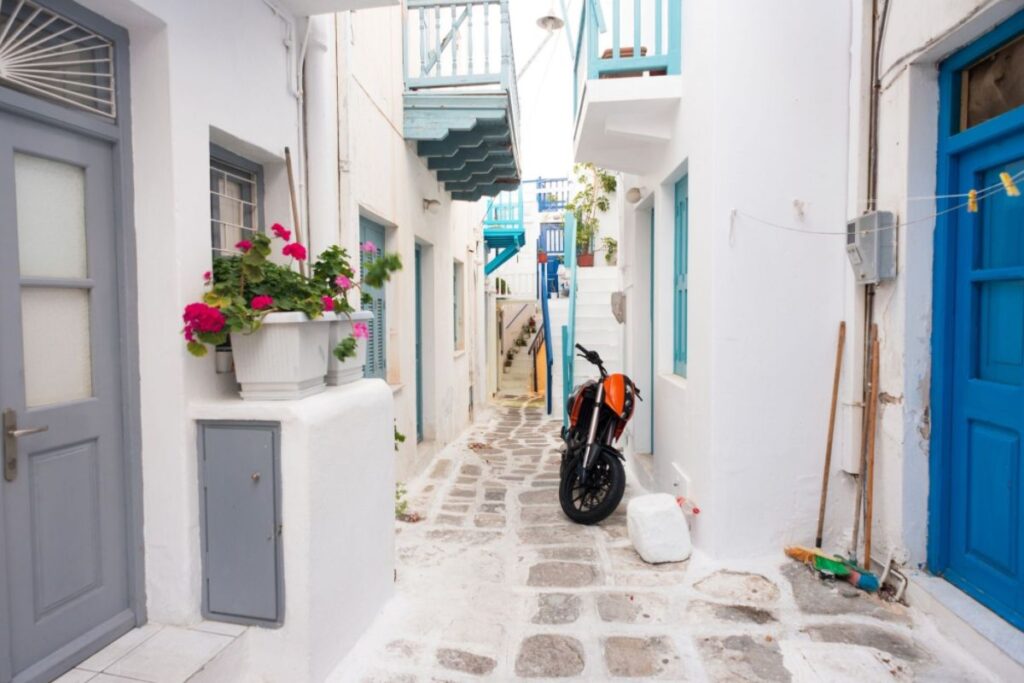 Mykonos chora with post of flowers and a motorbike