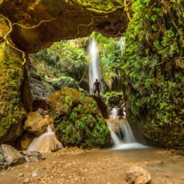 The impressive Nemouta waterfalls with a hiker in Greece
