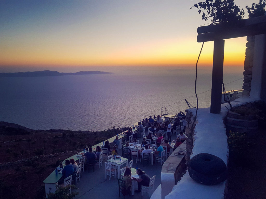 A winery at sunset with many people dinning at sunset.