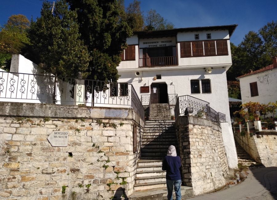 Milies Library with stairs with a tree an a person in Pelion Greece.