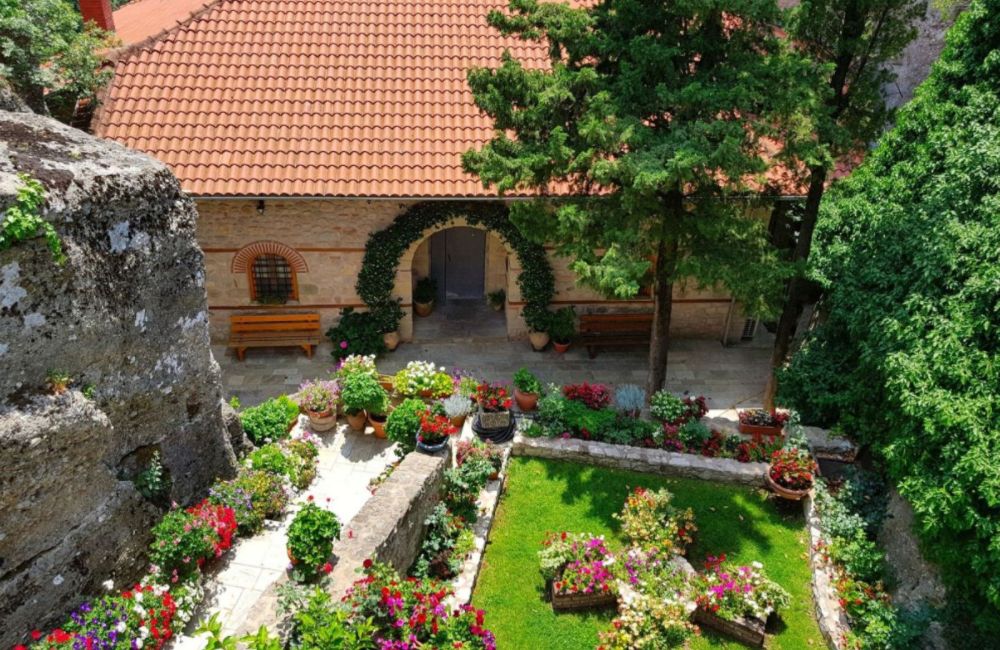 Meteora Monasteries garden with trees and pots.