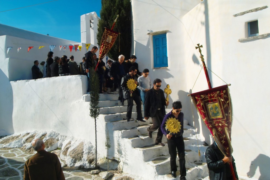 Procession of Icon on Sikinos Island and many people in a sunny day.