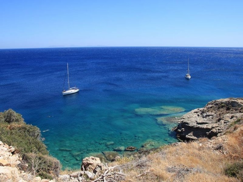 A beach with 2 yachts in a sunny day.