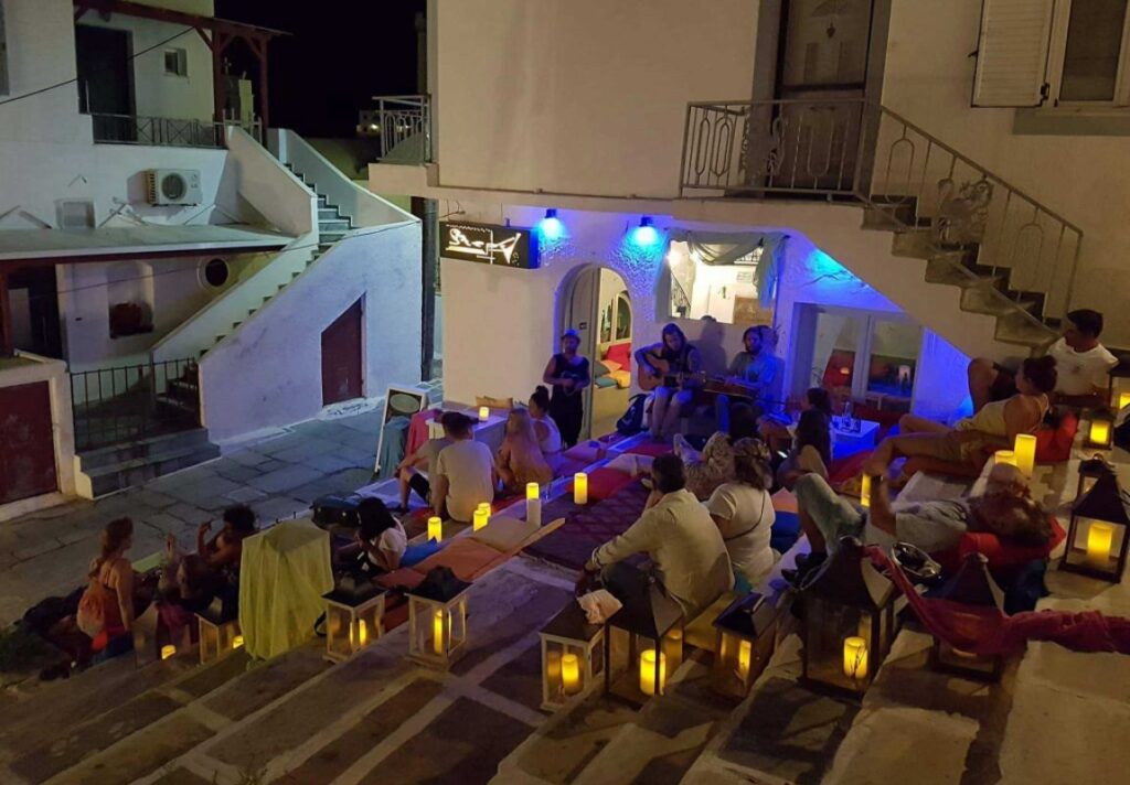Steps Bar at Chora Ios and many people sitting on the steps and having their drink.