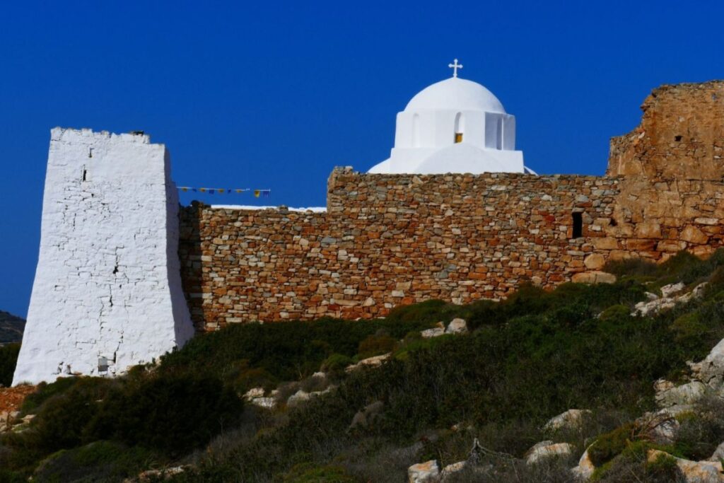 Whitewashed Monastery Zoodochos Pigi in a sunny day. Sikinos Greece.