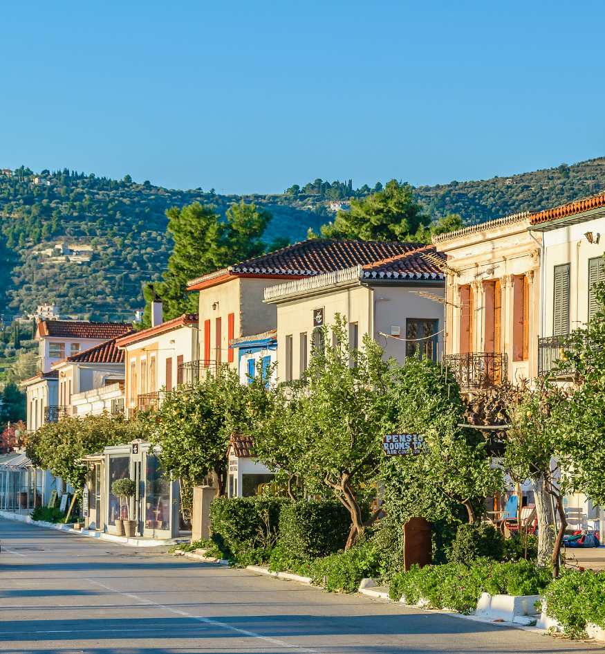 Colorful neoclassical mansions along the quiet harbor of the maritime town of Galaxidi, Greece in April.