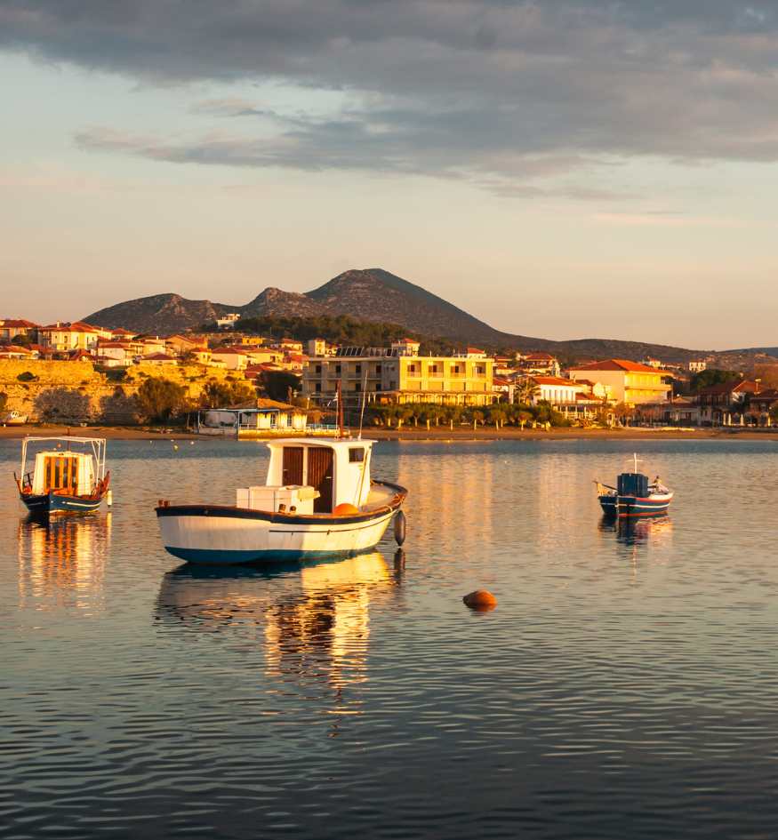 A small boat moored in the calm waters of Methni Peloponnese in sunset, Greece in April.