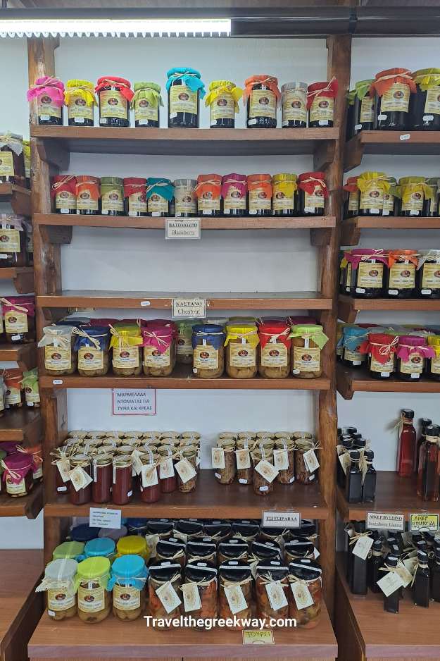 Shelves filled with colorful jars of homemade jams and preserves in a traditional shop in Portaria, Pelion.