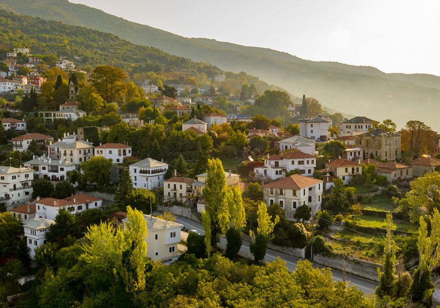 Many houses in the trees taken from a drone. Off-The-Beaten-Track Greece Destinations.