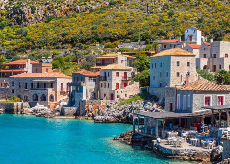 Limeni beach, some houses and a tavern beside the sea in a sunny day.