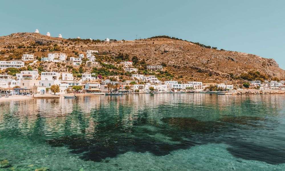 Whitewashed houses and shops beside the sea in Agia Marina, Leros. Off-The-Beaten-Track Greece Destinations.