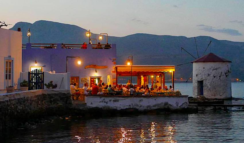 A tavern beside the sea with people having their dinner in Mylos Island.